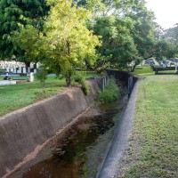 Just upstream of the hut, the drain passes through a lawn . . .